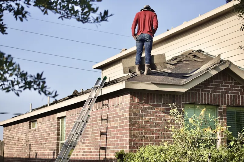 Professional roofer working on a residential roof in Maxim